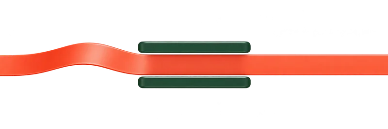 A smooth coral ribbon seen from above follows a clear path between two green rails.